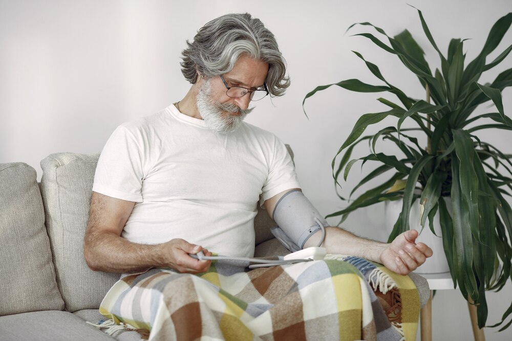 Closeup of senior male 70-75 years old measuring the pressure. Man to measure her blood pressure. Health and care.