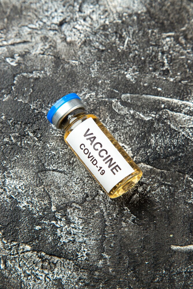 Top view antivirus vaccine in little flask on gray background health science lab pandemic virus covid- isolation hospital