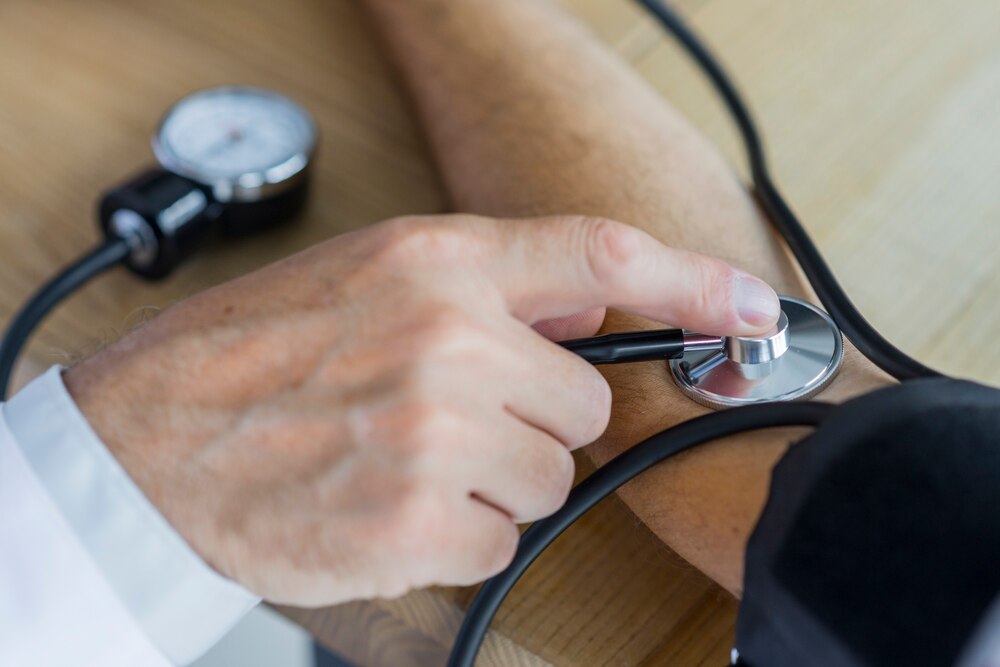 Crop hand measuring blood pressure of patient