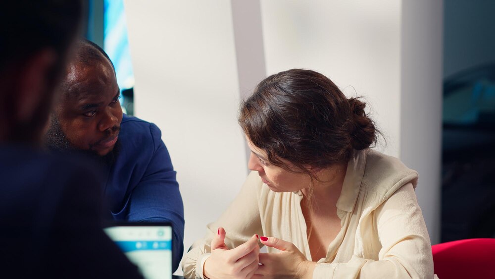 Husband and wife deliberating in car showroom deciding on price to pay