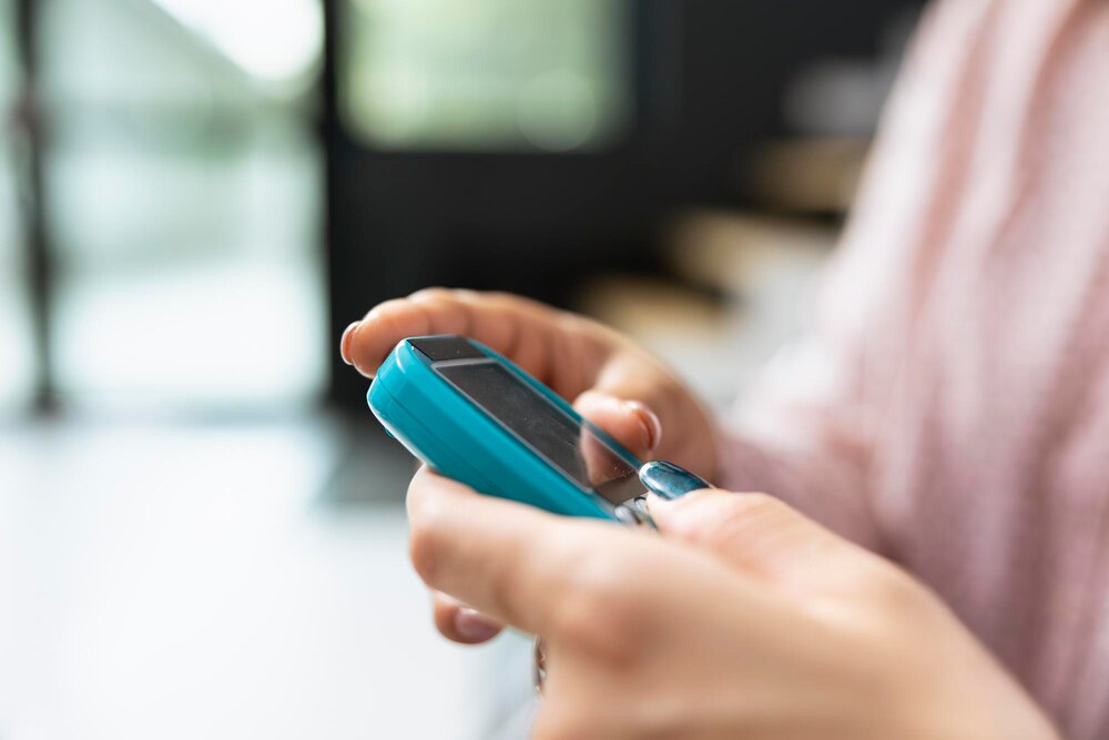 Nurse checking blood sugar levels using glucometer device