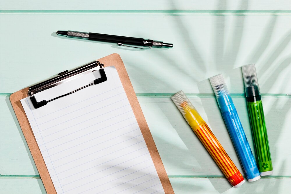 Copy space clipboard and colourful highlighters